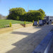 WADE BUILDING SUPPLIES | LARGE TIMBER DECKING AREA WITH GREEN RAILWAY SLEEPERS USED FOR STEPS AND RETAINING SLEEPER WALL 